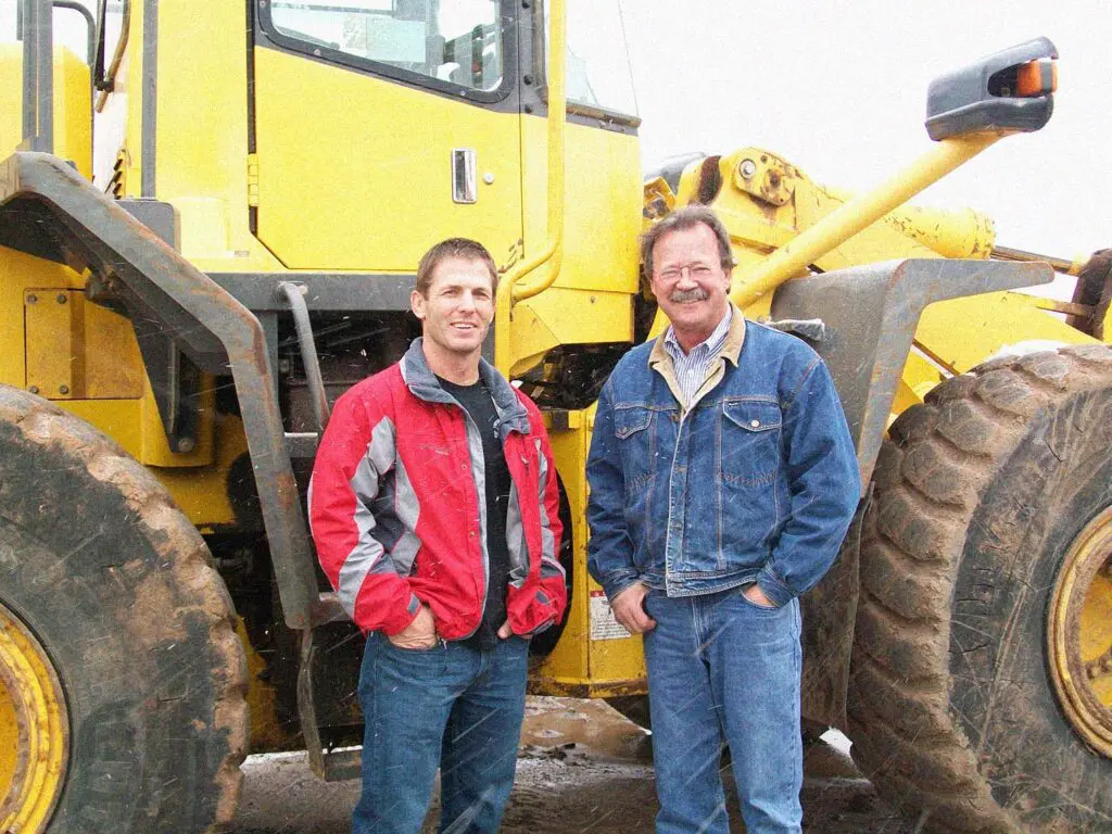 Photo of Site Work Specialist founders standing in front of machinery